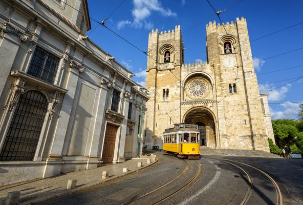 Old Tram In Front Of Cathedral In Lisbon Portugal